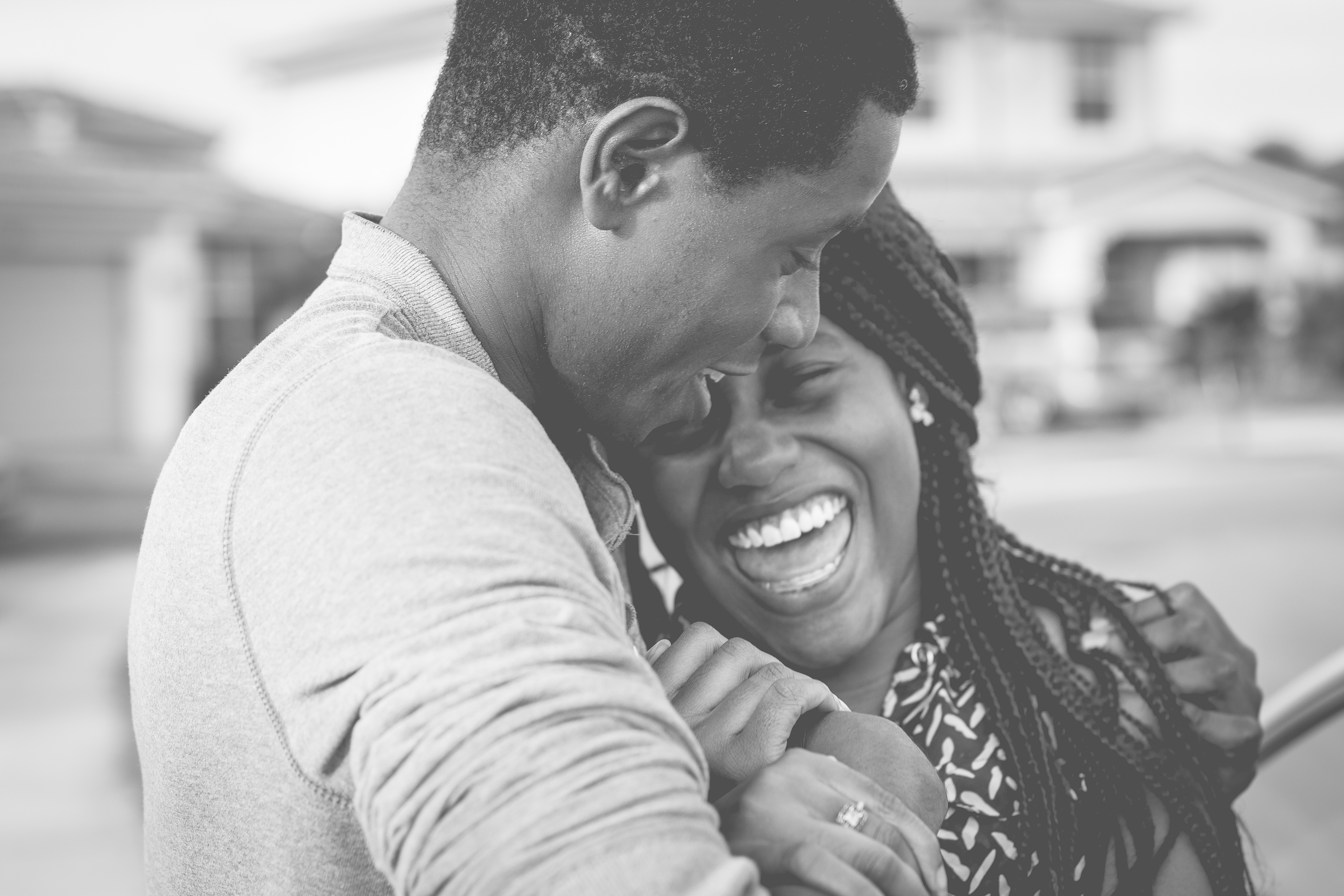 A young couple embracing and laughing 